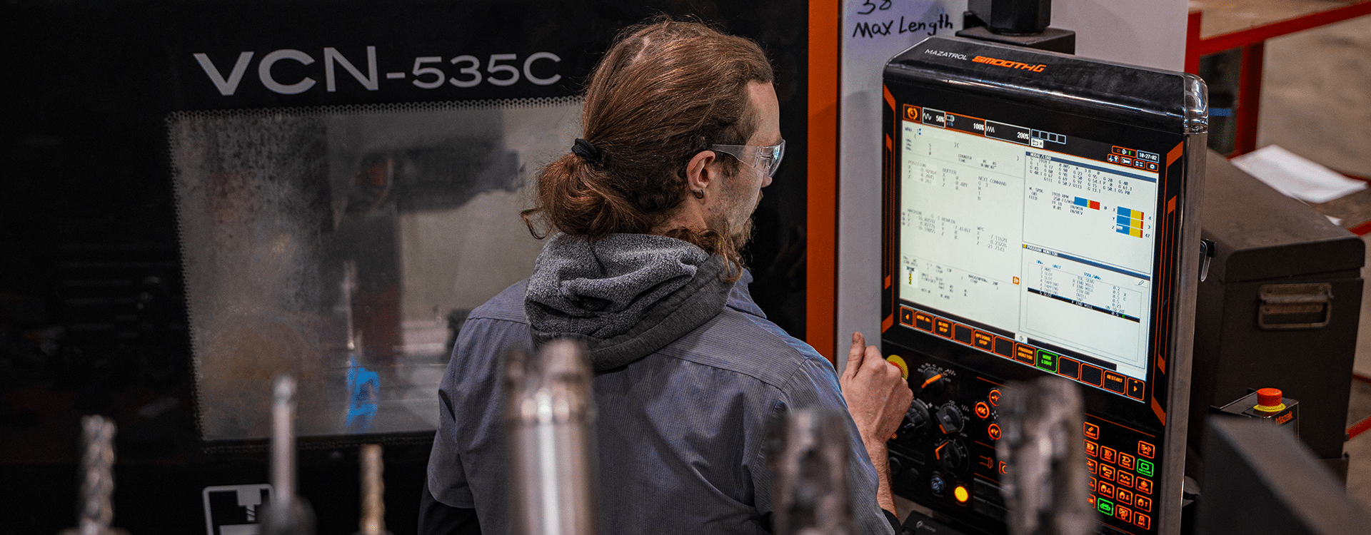 Precision CNC Milling at AIM Industrial Machine Shop Mazak VCN-535C operator performing CNC milling at Advanced Industrial Machine's machine shop in Greenville, Wisconsin.