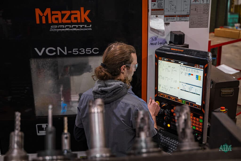 Mazak VCN-535C operator performing CNC milling at Advanced Industrial Machine's machine shop in Greenville, Wisconsin.